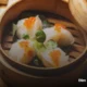 Traditional dim sum dishes including dumplings and buns in a London restaurant
