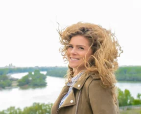windblown curly hair on a bright day
