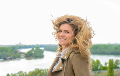 windblown curly hair on a bright day