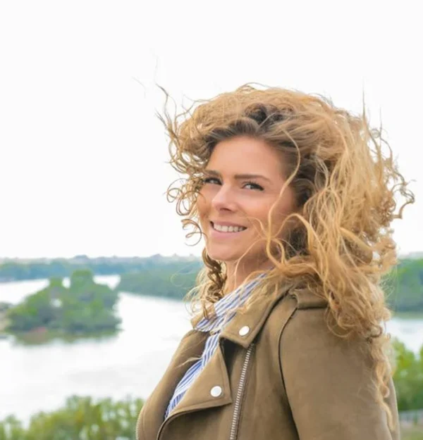 windblown curly hair on a bright day