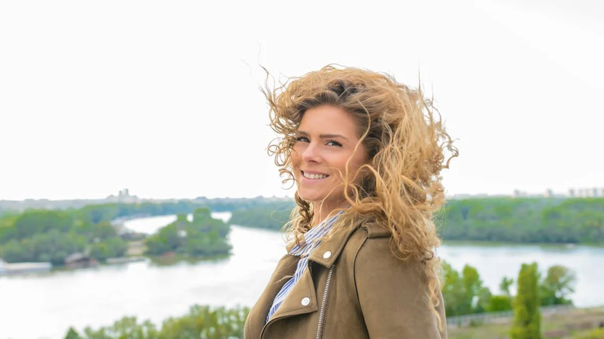 windblown curly hair on a bright day