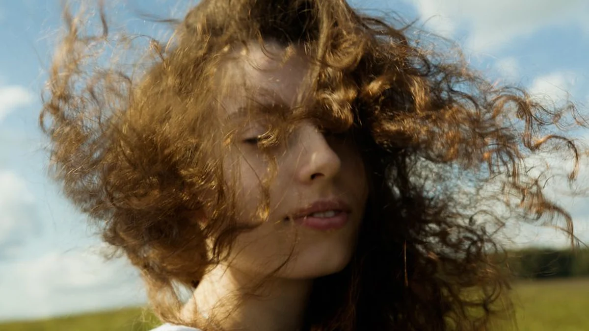 hair blown across the face outdoors