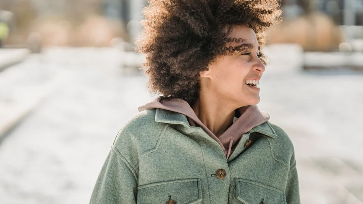 woman with curly hair outdoors in the snow
