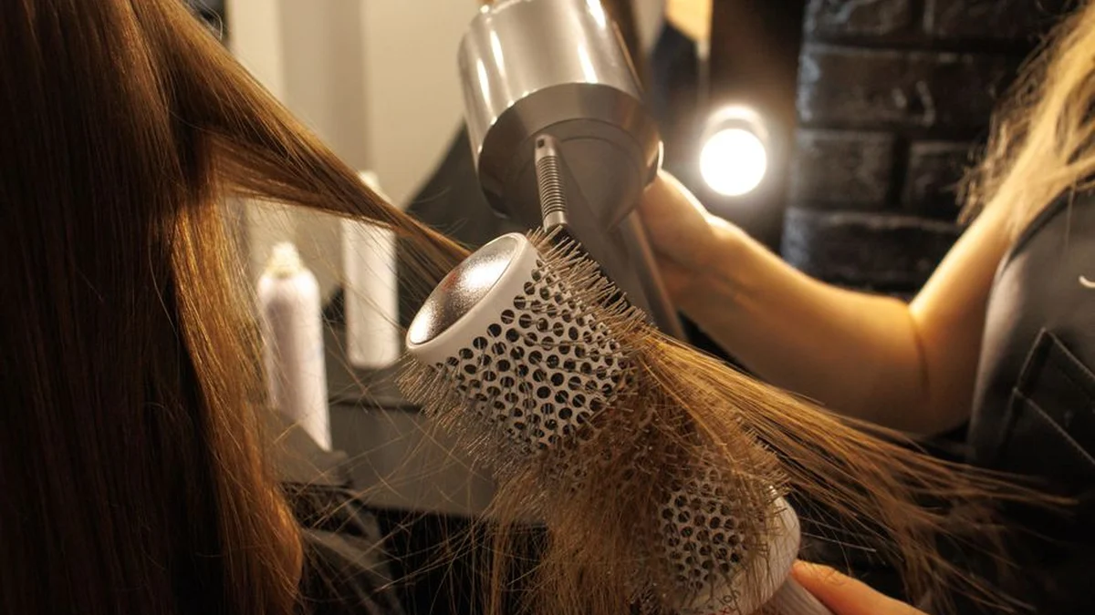 blow drying with a round brush in a salon