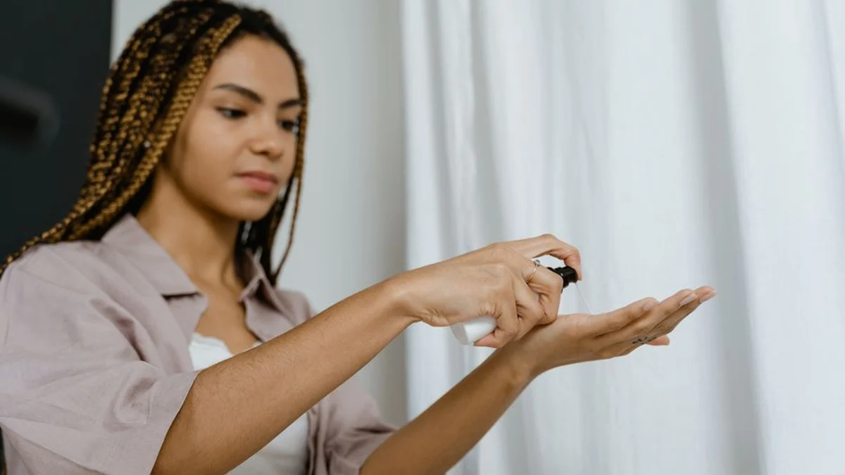 dispensing curl cream into the palm of a hand