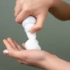 dispensing hair mousse into an open palm