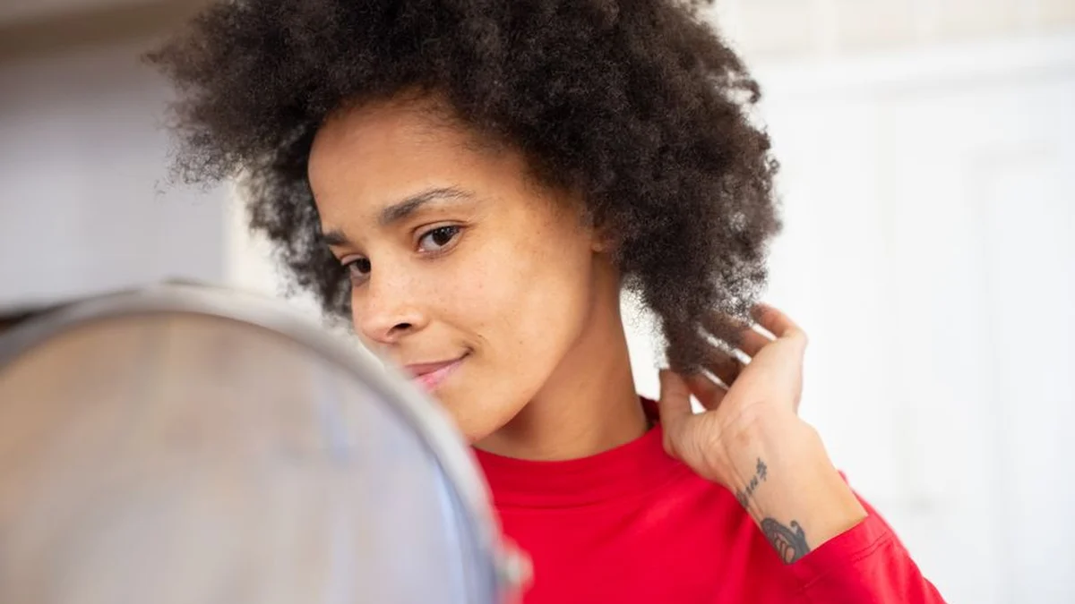 checking voluminous curls in a mirror