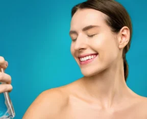 woman holding a clear spray bottle for her hair