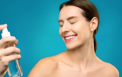woman holding a clear spray bottle for her hair