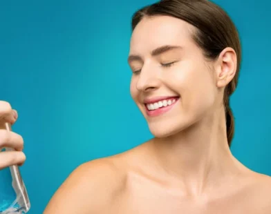 woman holding a clear spray bottle for her hair