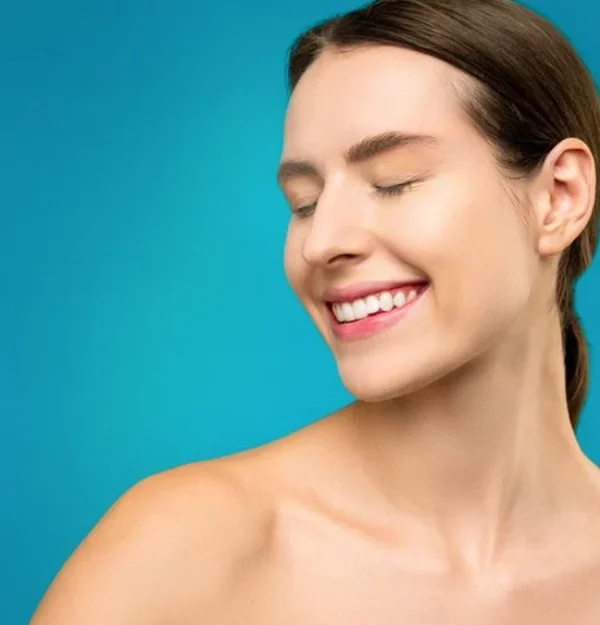 woman holding a clear spray bottle for her hair