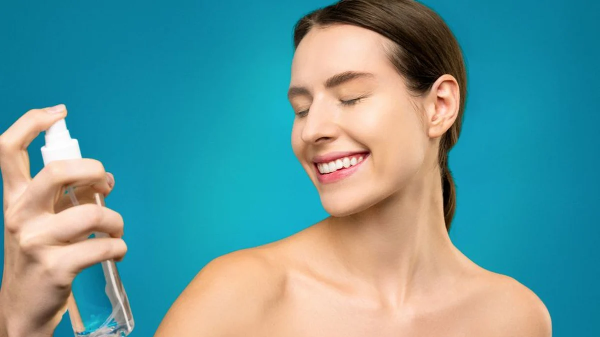 woman holding a clear spray bottle for her hair
