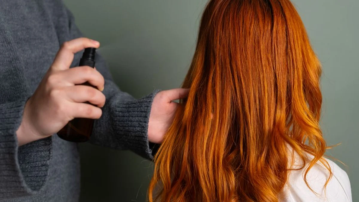spraying product through long hair section by section