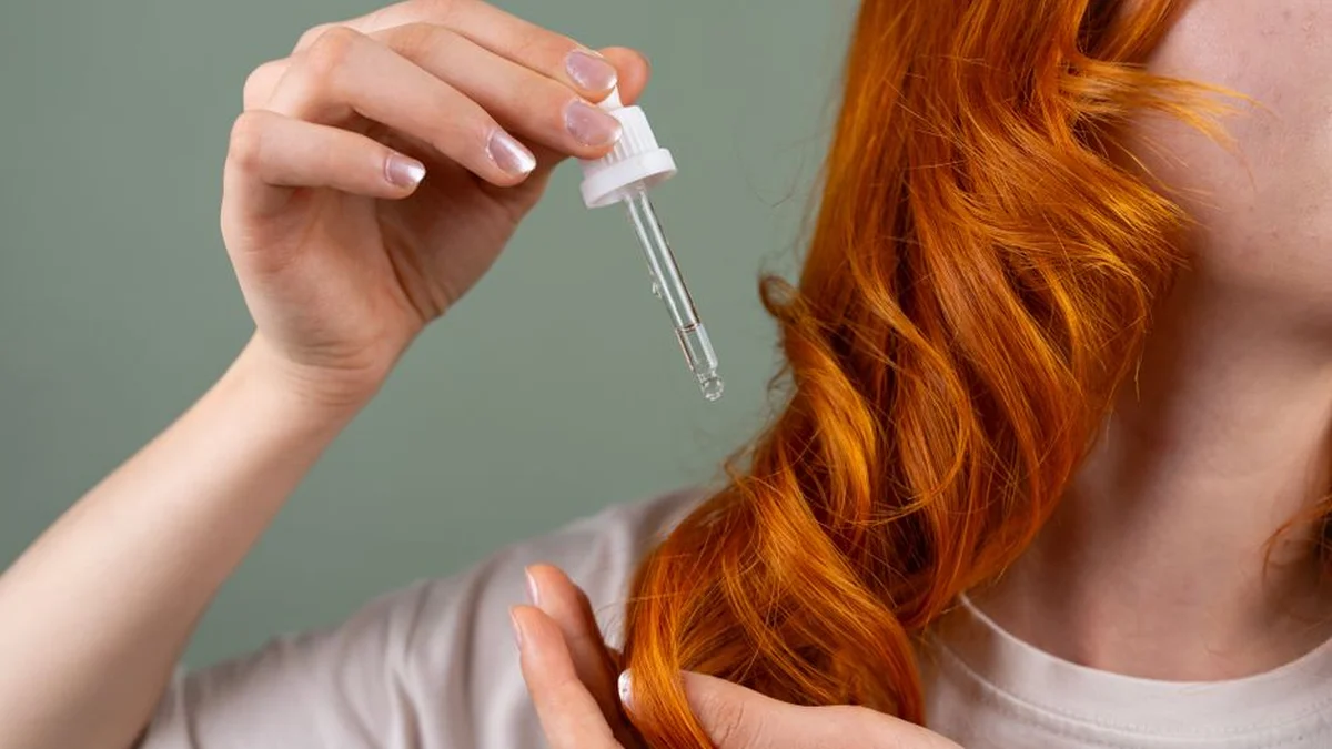 using a dropper to apply treatment to hair