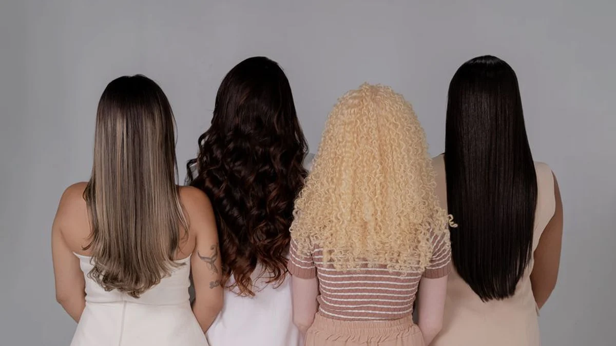 four women photographed from behind showing different hair textures