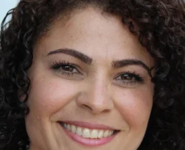woman with defined natural curls smiling