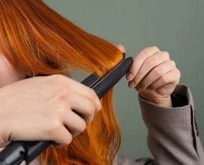 using a flat iron on long red hair