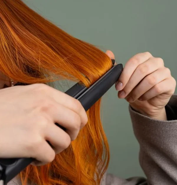 using a flat iron on long red hair