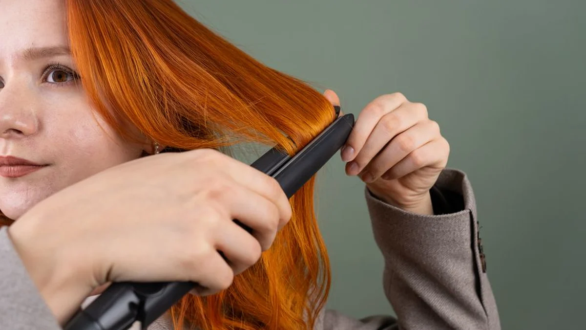 using a flat iron on long red hair