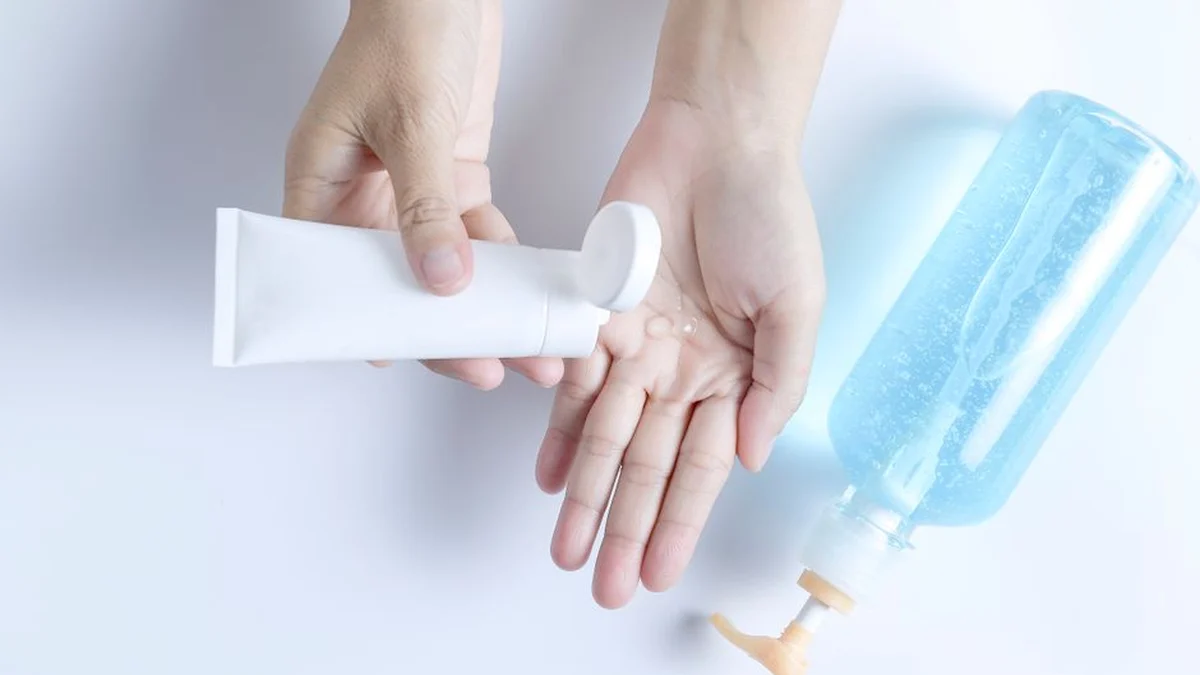 squeezing gel from a tube into the hand