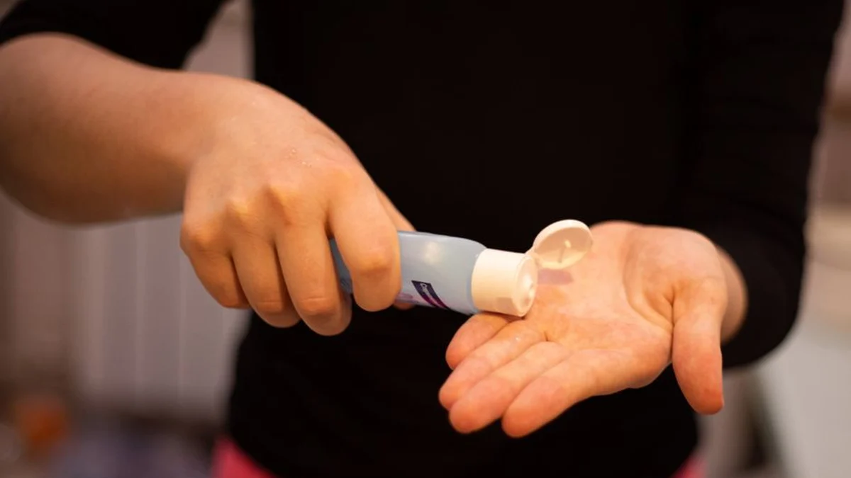 applying gel from a bottle to the hands