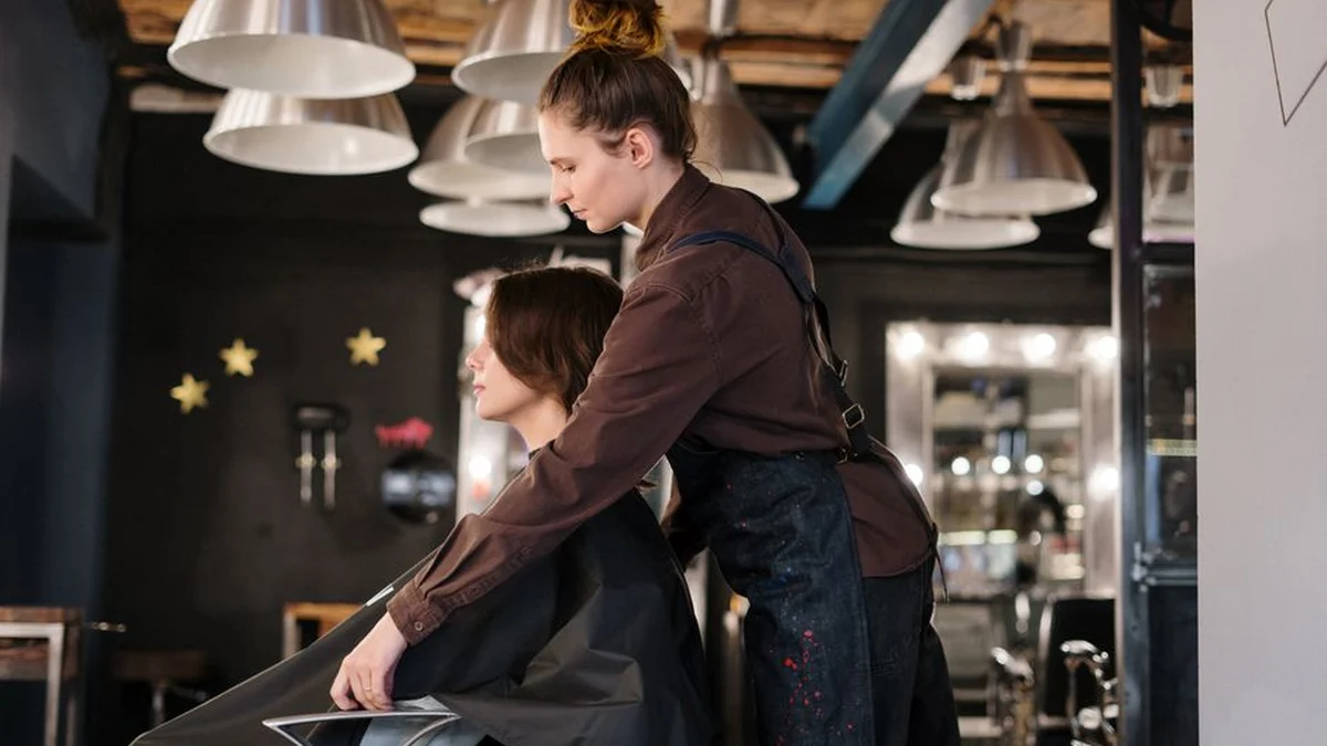 stylist working on a client in a salon chair