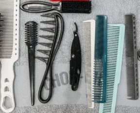 a flat lay of combs, brushes, scissors and styling tools
