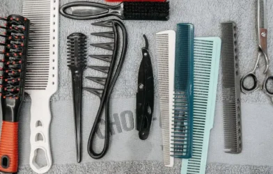 a flat lay of combs, brushes, scissors and styling tools