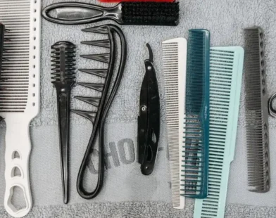 a flat lay of combs, brushes, scissors and styling tools