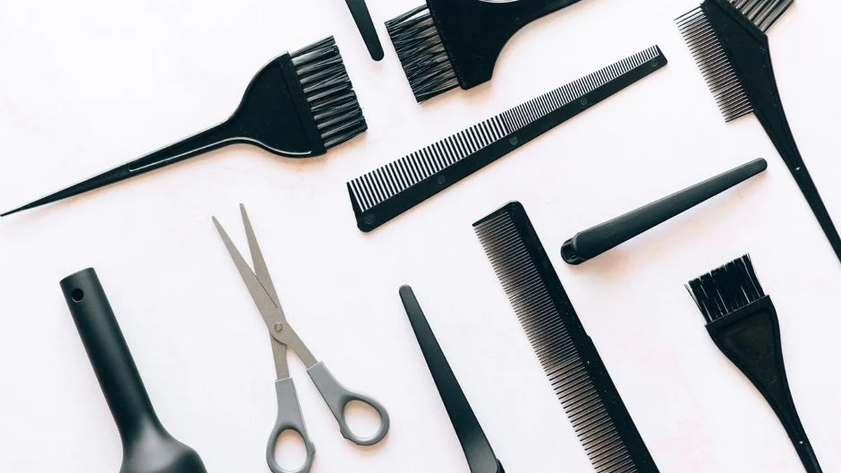 brushes, combs and scissors laid out on a work surface