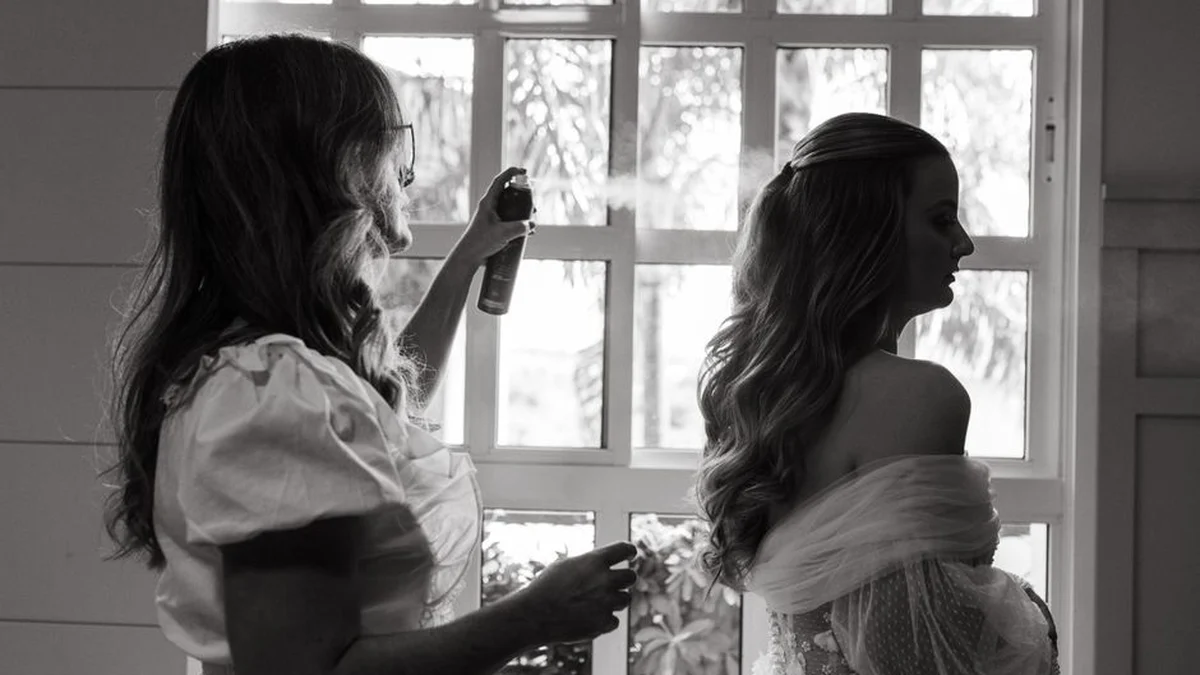 stylist spraying a finished style